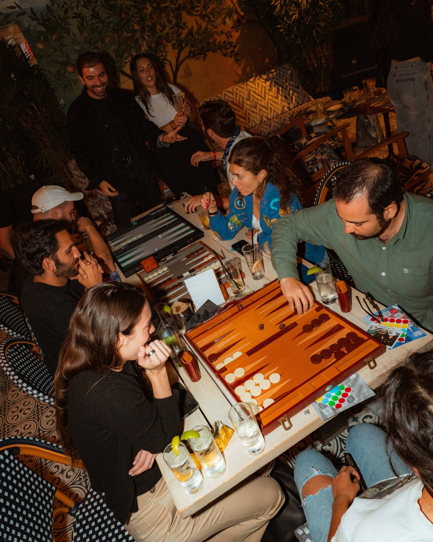 A packed room of backgammon tables in Manhattan